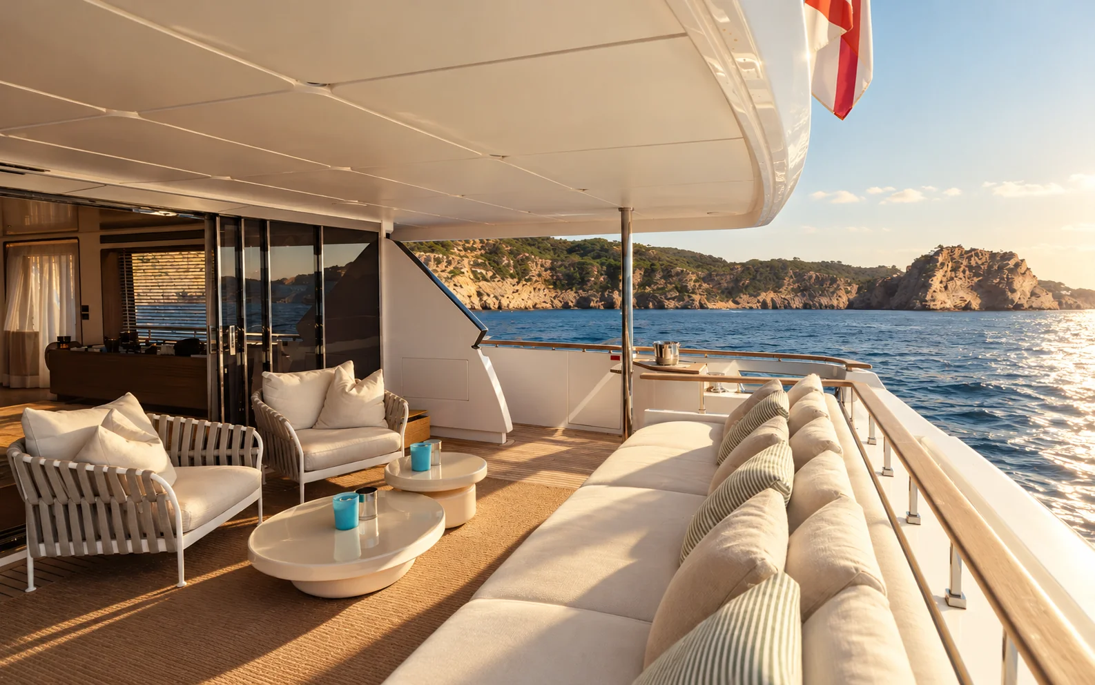 The shaded aft lounge, with cream seating overlooking the sea.